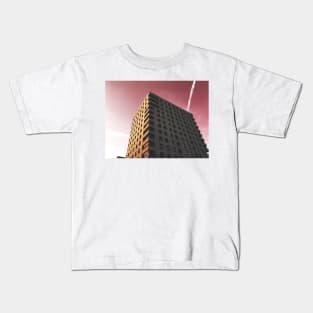 Towering architecture against a wine red sky Kids T-Shirt